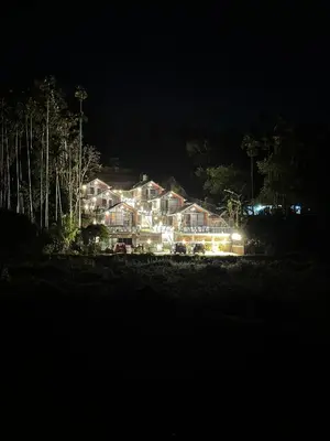 a large house lit up at night with lights at Misty Slope in Panamaram