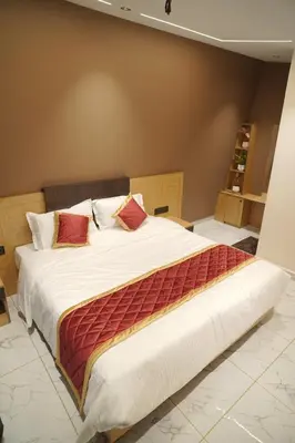 a bedroom with a large bed with red pillows at Bougainvillea HillView Retreat in Palakkad