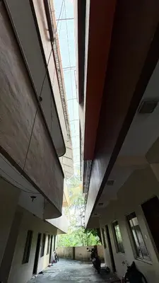 an empty hallway of a building with a glass ceiling at Chandras appartment in Palakkad