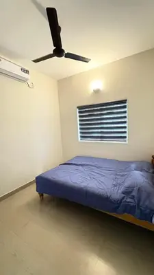 a bedroom with a bed and a ceiling fan at Chandras appartment in Palakkad
