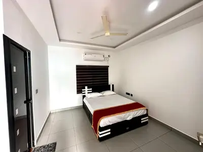 a bedroom with a bed and a ceiling fan at Cloud Lacasa in Athirappilly