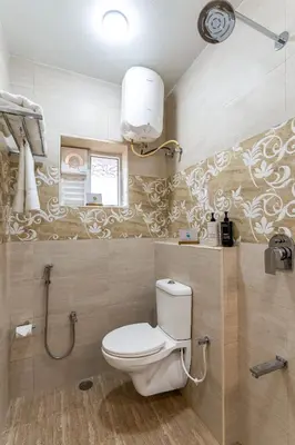 a bathroom with a toilet and a window in it at Mihirika's Nirvana 5-BHK With Garden, Gazebo, Bonfire Pit & Scenic Views in Ooty