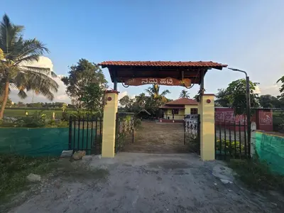 a gate with a sign in front of a house at Namma Hatti, Traditional Home in Chattanahalli
