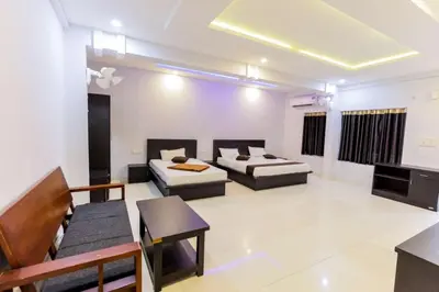 a living room with two beds and a couch at Igloo Residency in Vythiri