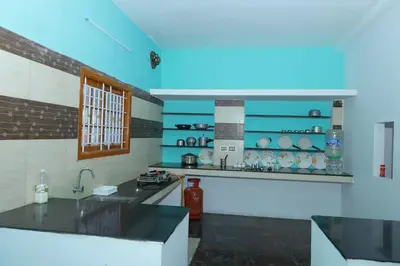 a kitchen with a counter and a sink in a room at 2Bhk White House Near Isha By Shivalaya Stays in Coimbatore