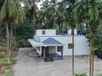 a small building with a roof on the side of a building at 2Bhk White House Near Isha By Shivalaya Stays in Coimbatore