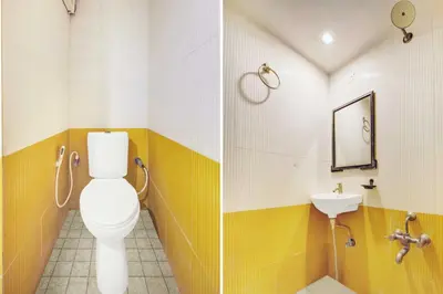a bathroom with a toilet and a sink at Super Townhouse Oak Mysuru City Bus Terminal in Mysore
