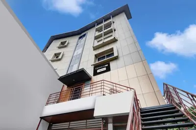 a tall building with a sign on it at Super Townhouse Oak Mysuru City Bus Terminal in Mysore