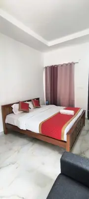 a bedroom with a large bed in a room at Blue home stay in Kanthalloor