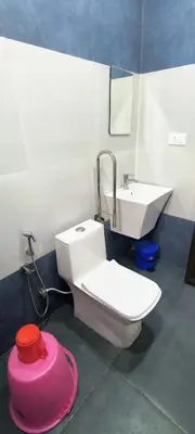 a bathroom with a toilet and a sink at Blue home stay in Kanthalloor