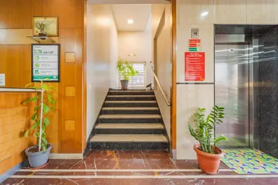 a staircase in a building with potted plants at Treebo Akshaya Palace Inn in Mysore