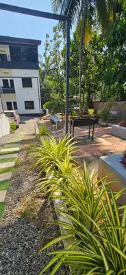 a park with a bench in front of a building at Anam residence in Tāzhekkod