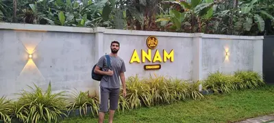 a man standing in front of a wall with an amazon sign at Anam residence in Tāzhekkod