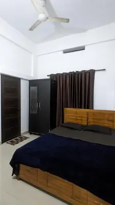 a bedroom with a bed and a ceiling fan at Anam residence in Tāzhekkod