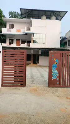 a building with a gate with a painting on it at Aswathy Bhavan Vadakkenchery Near Star auditorium in Vadakkāncheri