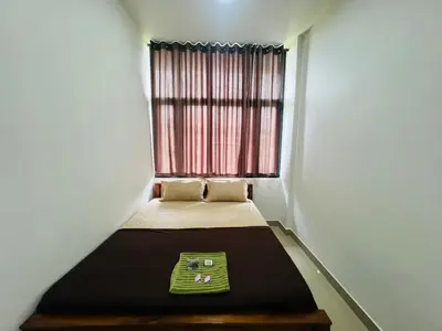 a small bed in a room with a window at Mundodan complex in Nilambūr