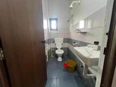 a small bathroom with a toilet and a sink at Mundodan complex in Nilambūr