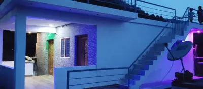 a house with a staircase with a blue light at Misty plaza in Munnar
