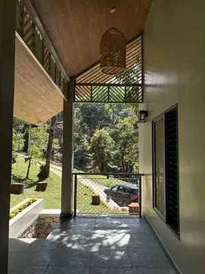 a view from the inside of a house with a patio at Lucas Rainforest in Kakkabe