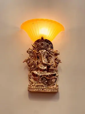 a gold lamp with at Vaj N Sat Villas in Kodaikānāl