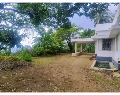 a house with a dirt yard in front of it at Maanasam Farmstay - Boutique 3BR Countryside Villa, Manikkadavu in Irrity