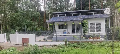a small house with a fence around it at Tusker villa in Suntikoppa