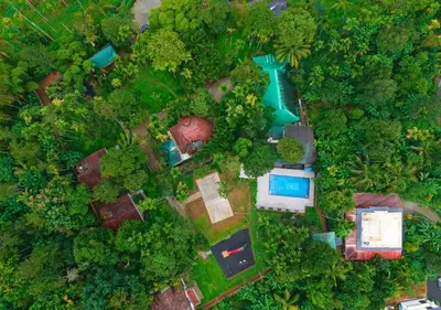 an overhead view of a park with a pool and trees at Kedara Resort Wayanad by VOYE HOMES - Pet Friendly with Pool in Sultan Bathery