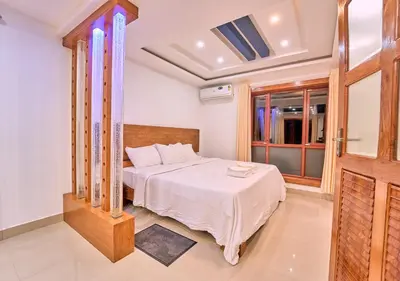 a bedroom with a bed and a window at Kedara Resort Wayanad by VOYE HOMES - Pet Friendly with Pool in Sultan Bathery