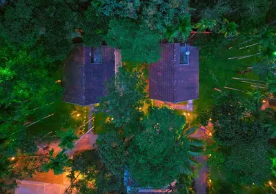 an overhead view of a house with trees and lights at Kedara Resort Wayanad by VOYE HOMES - Pet Friendly with Pool in Sultan Bathery