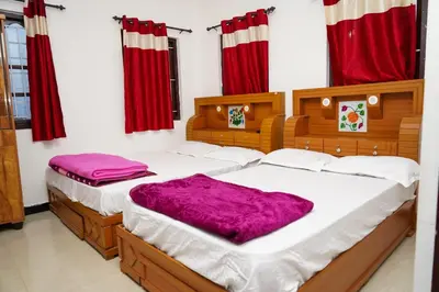 two twin beds in a room with red curtains at Climate Dull - Homestay Villa in Ketti