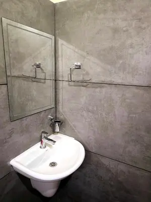 a bathroom with a sink and a mirror at Tranquil Nest Villa - Wayanad in Kalpetta
