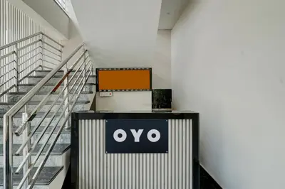 a sign on a wall next to some stairs at Hotel O Ambari Residency in Mysore