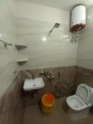 a bathroom with a white toilet and a sink at Maruthamalai Andavar Residency in Coimbatore