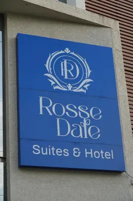 a sign on the side of a building at Rosse Dale Suites and Hotel Coimbatore in Coimbatore