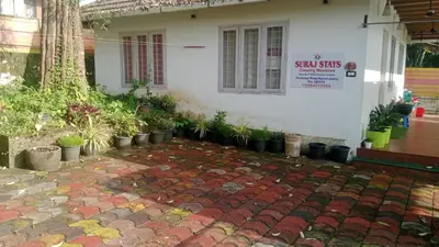 a house with a sign on the side of it at Suraj Stays Glowing Meadows in Chewarra