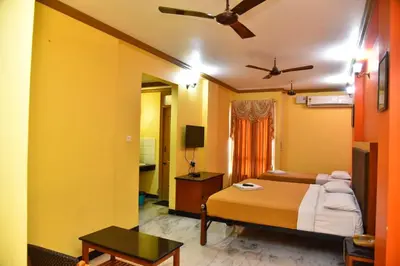 a bedroom with a bed and a ceiling fan at Hotel Grand Palace in Coimbatore