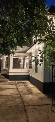 a white building with a fence on the side of it at Chunangad in Ottappālam