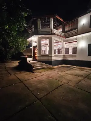 a building at night with a bench in front of it at Chunangad in Ottappālam
