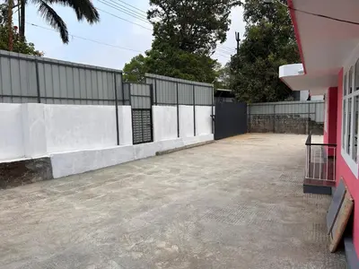 an empty parking lot next to a fence at Fog view cottage - Homestay with food and internet in Vythiri