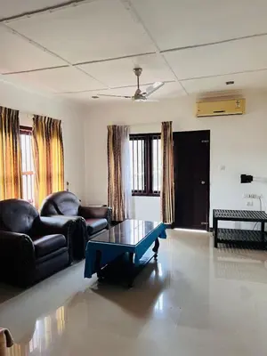 a living room with a couch and a coffee table at Tapovan Green County Resorts in Thattakād