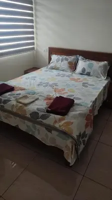 a bed with a colorful comforter in a bedroom at City Nature-view apartment in Kozhikode