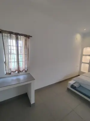 a room with a bench and a window at 3BHK - Villa - a greece style - Kayal vizha - near isha yoga - coimbatore in Coimbatore