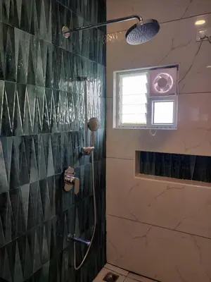 a bathroom with a shower with a glass wall at 3BHK - Villa - a greece style - Kayal vizha - near isha yoga - coimbatore in Coimbatore