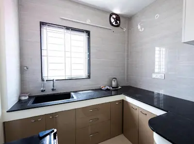 a kitchen with a sink and a window at Sree Home Stay and Service Apartment Coimbatore in Irugūr