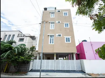 a tall building with a fence in front of it at Sree Home Stay and Service Apartment Coimbatore in Irugūr