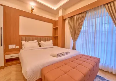 a bedroom with a large bed with a large window at Villa Terra Verde Ooty by VOYE HOMES in Ooty