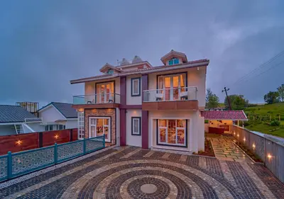 a house with a large driveway in front of it at Villa Terra Verde Ooty by VOYE HOMES in Ooty