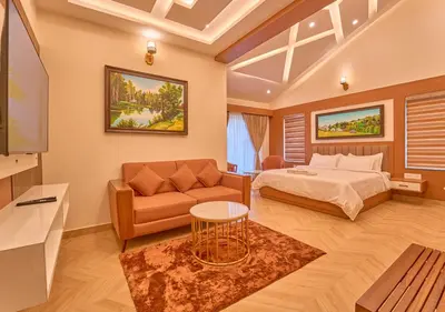 a bedroom with a bed and a couch at Villa Terra Verde Ooty by VOYE HOMES in Ooty