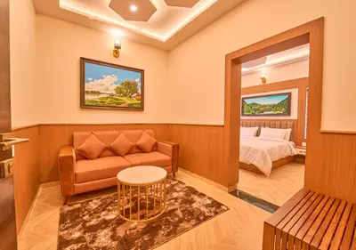 a living room with a couch and a bed at Villa Terra Verde Ooty by VOYE HOMES in Ooty