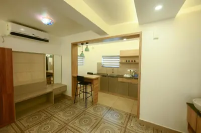 a kitchen with a counter and a stool in a room at Paradise-Vadanappally Beach Villa for 4-5 adults in Irimbranallūr
